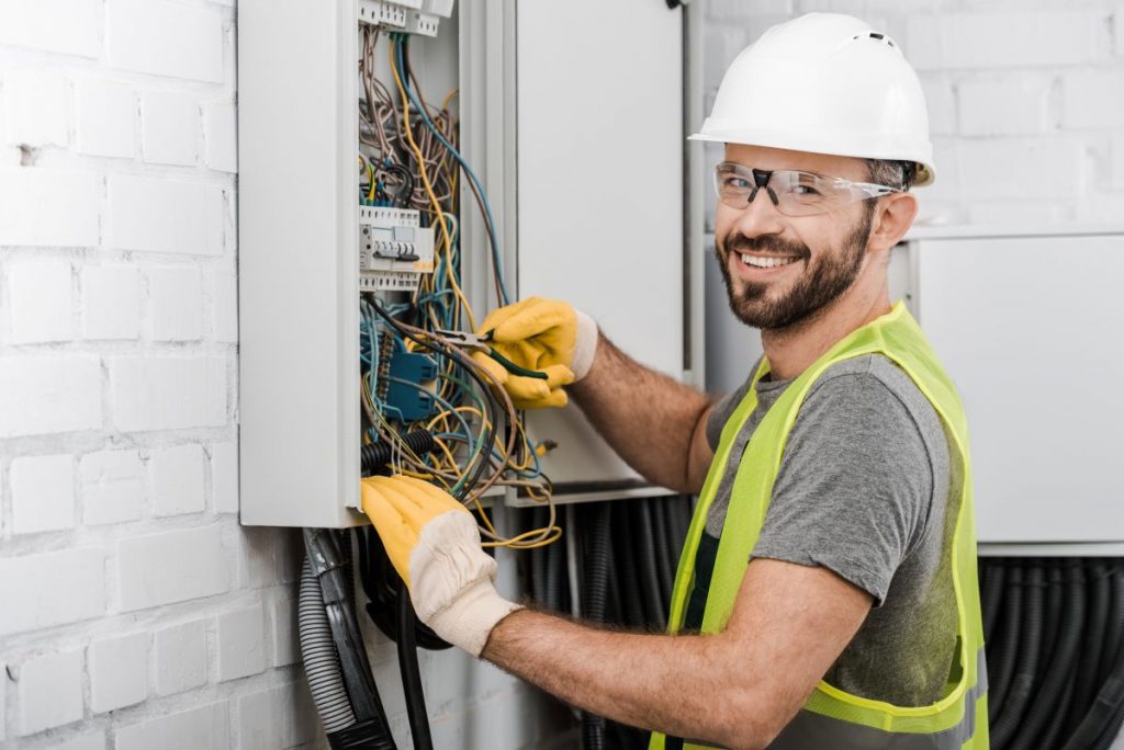man working on house fuse box