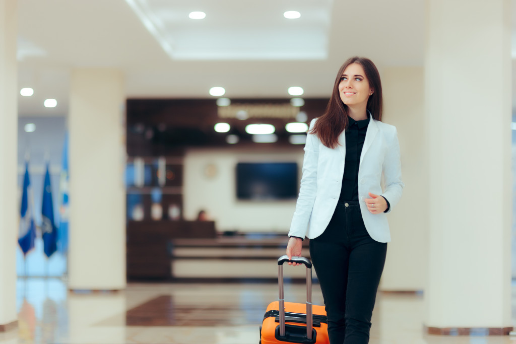 woman in smart office outfit with her luggage