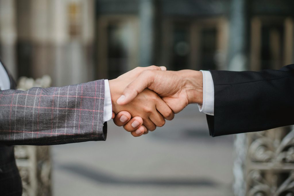 Business owner and customer shaking hands